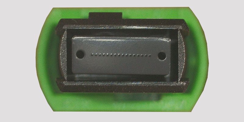 MPO/APC 16 position ferrule face showing fibers &amp offset key
